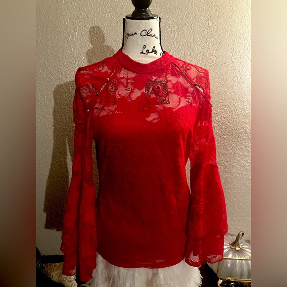 Bracelet-length bell sleeves top with lace and peek-a boo shoulders. - Picture 1 of 5